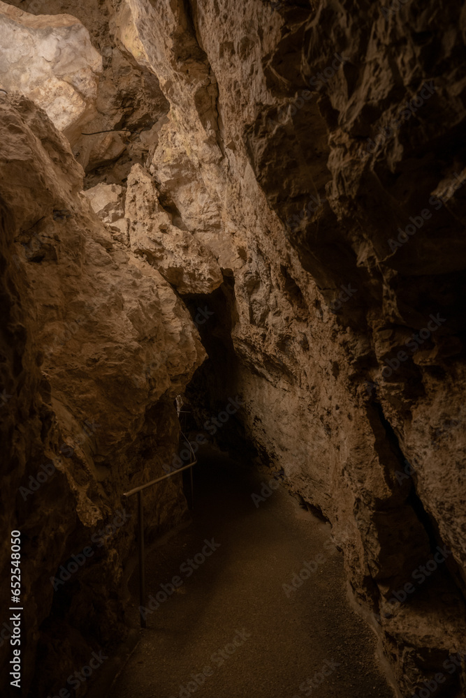 Paved Pathyway Disappears into Rock Archway in Carlsbad Caverns