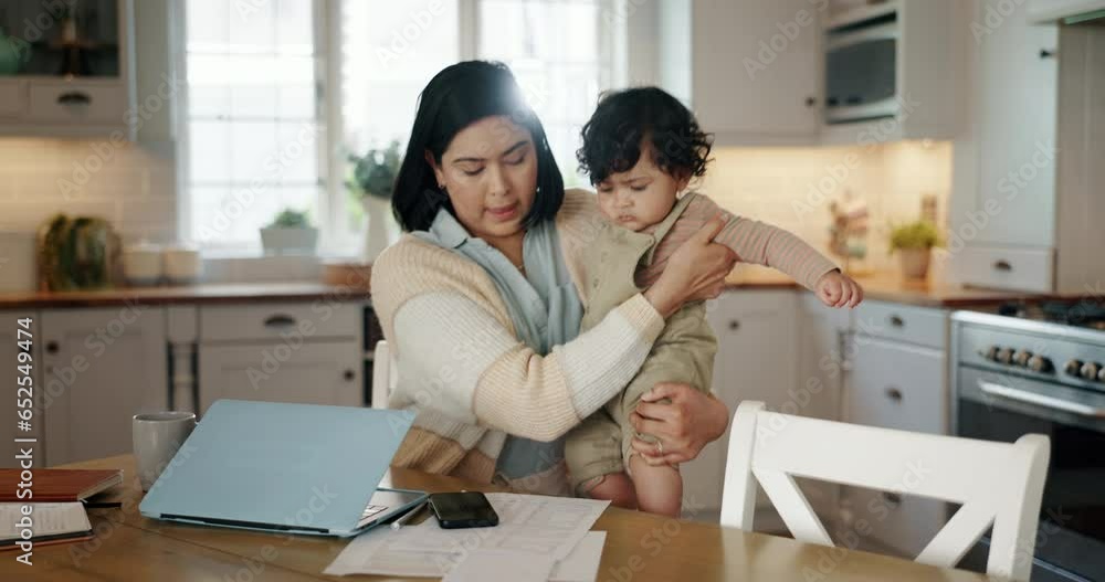 Remote work, multitasking and mother with baby in a kitchen on a laptop for telework or productivity at home. Freelancer, balance and mom with newborn online in a house, juggle or time management Remote work, multitasking and mother with baby in a kitchen on a laptop for telework or productivity at home. Freelancer, balance and mom with newborn online in a house, juggle or time management