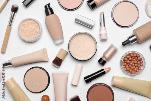 Face powders and other makeup products on white background, flat lay