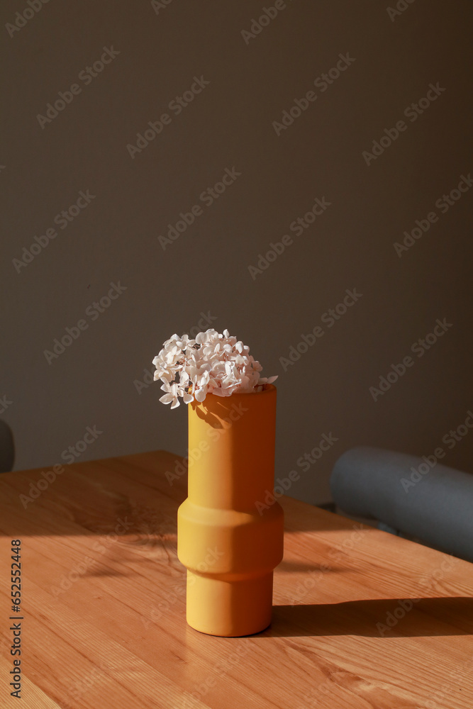 Pink flower in yellow vase with morning sunlight from window on wooden table. Blossom flower bouquet. Advertising, Space, Foliage, Shadow