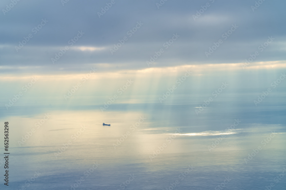 Shafts of sunlight break through the clouds over a great lakes freighter, Lake Superior, Michigan. Shafts of sunlight break through the clouds over a great lakes freighter, Lake Superior, Michigan.