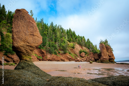 Romantic couple holding hands visiting Hopewell Rocks Provincial Park at low tide, Bay of Fundy, Hopewell Cape, New Brunswick, Canada. Photo taken in September 2023.