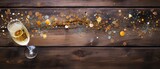 A sparkling glass of champagne with golden accents on a rustic wooden table