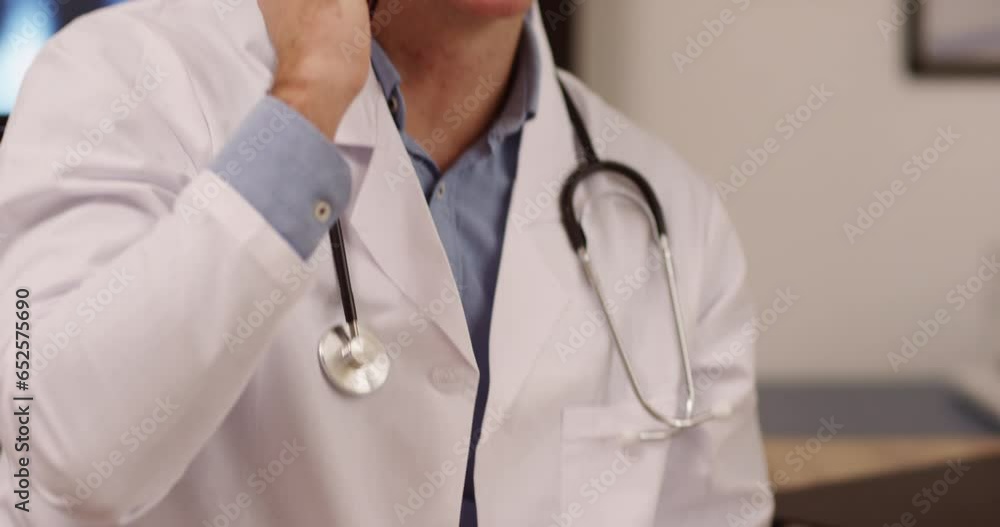 Phone call, laptop and male doctor doing a telehealth consultation in his office in the hospital. Phone call, laptop and male doctor doing a telehealth consultation in his office in the hospital.