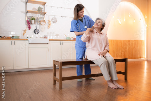 Asian nurse taking care of senior woman in nursing home. Healthcare and medical service.