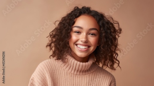The vibrant smile of a teenage girl lights up this studio portrait.