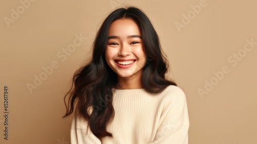 An exuberant girl with a beaming grin, embodying the essence of youthful joy in a studio setting.