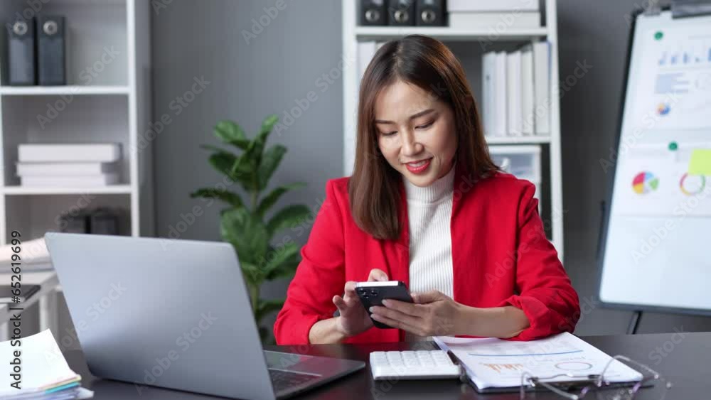 Attractive Asian businesswoman Use your laptop to watch your computer and talk on the phon. Consult customers, sit at a table. financial officer making a mobile business call Discuss work with clients Attractive Asian businesswoman Use your laptop to watch your computer and talk on the phon. Consult customers, sit at a table. financial officer making a mobile business call Discuss work with clients