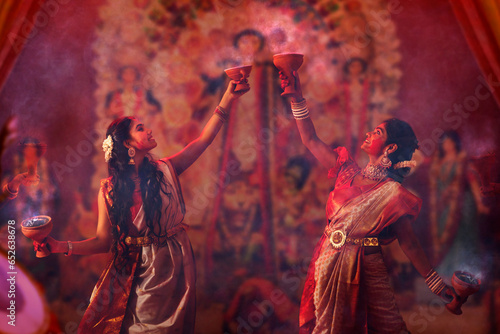 Bengali women performing dhunuchi dance on the occasion of Durga Puja