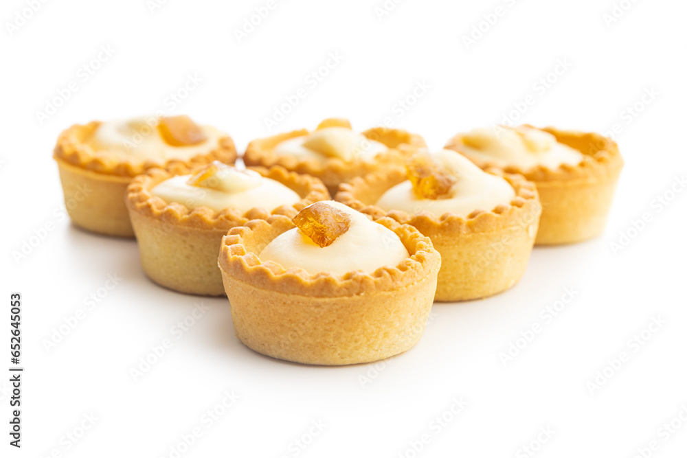 Sweet tarlets. Tasty mini tarts. Mini pie with cream isolated on white background.