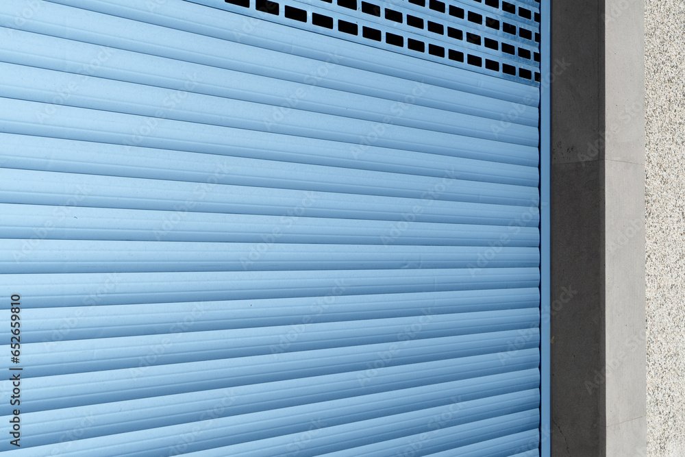 Roller shutter gate. Metal roller garage door as background. Automatic