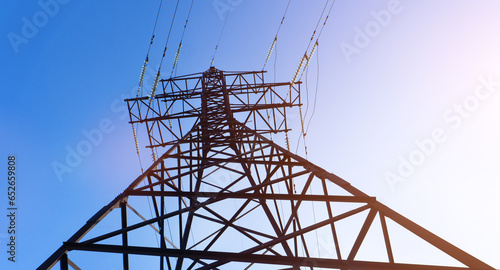 Power line. High-voltage power transmission tower with wires. High voltage line. Energy industry. Energy transfer over blue sky. Energy industry. Power substation..