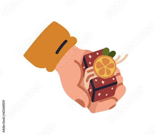 Hand holding tiny gift box, presenting Christmas surprise. Giving Xmas giftbo...