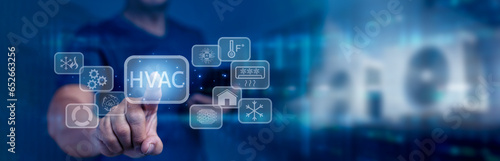 Businessman touching on virtual screen and presses HVAC button. Use of various technologies to control the temperature, humidity, and purity air. HVAC - Heating Ventilation Air Conditioning Concept