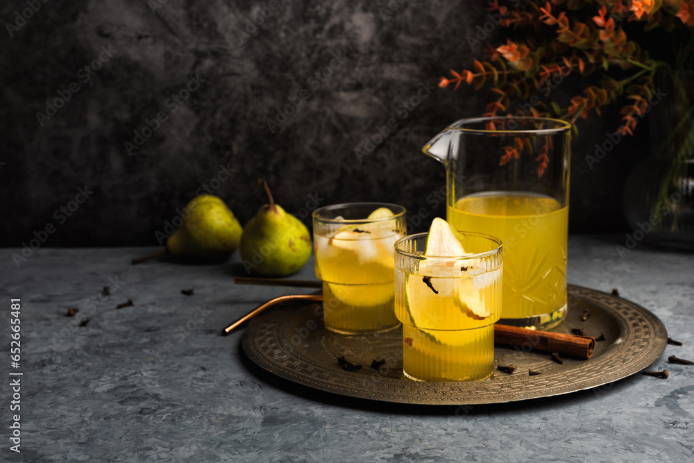 Autumn ice cider cocktail with apple and pear on the gray table. Glass of sangria or punch Autumn ice cider cocktail with apple and pear on the gray table. Glass of sangria or punch