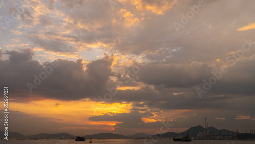 Beautiful sunset sky with white clouds and yellow sun serene sea view