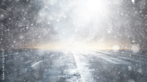 snowfall  car  background in a snowstorm with a copy of the space  the headlights of an oncoming car through a thick snowfall  winter view on the highway  headlight light