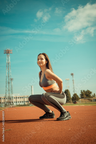 Obraz na płótnie Beautiful woman training on the tracks on a sunny morning w salonie