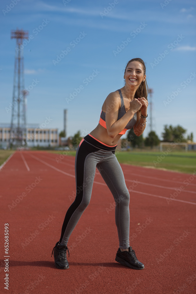 Beautiful woman training on the tracks on a sunny morning