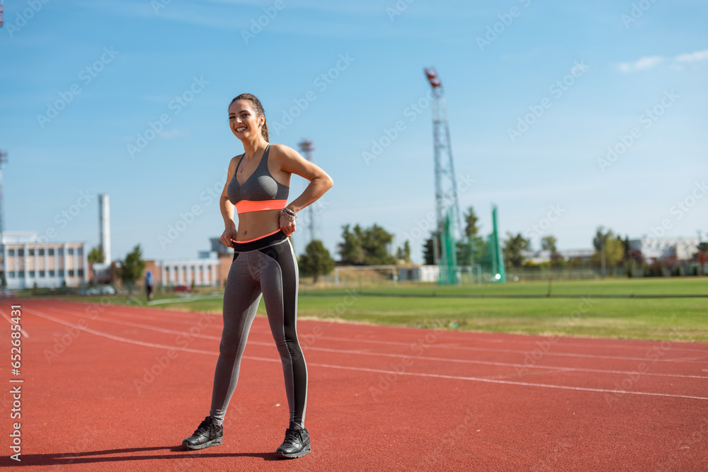 Beautiful woman training on the tracks on a sunny morning