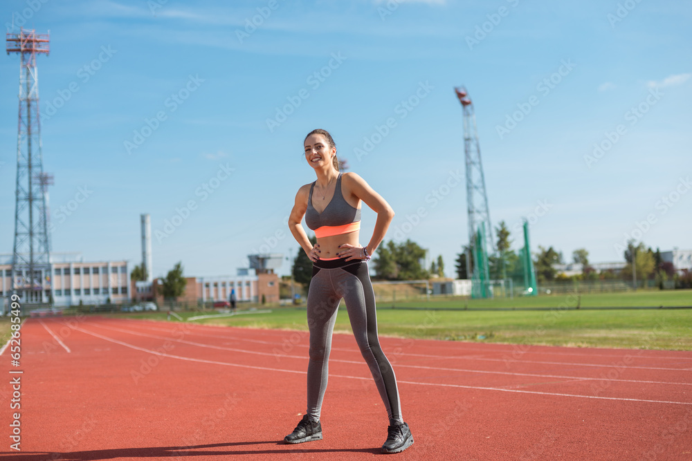 Beautiful woman training on the tracks on a sunny morning