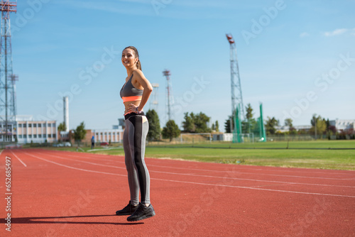 Obraz na płótnie Beautiful woman training on the tracks on a sunny morning w salonie