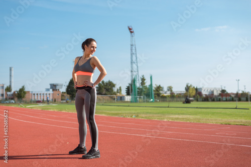 Obraz na płótnie Beautiful woman training on the tracks on a sunny morning w salonie