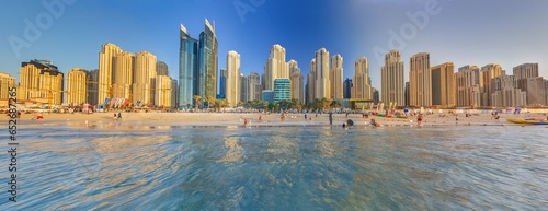 Panoramic view over beach and skyline of Marina district in Dubai during sunset