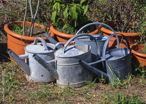 Metal watering cans in Provence region of France photo