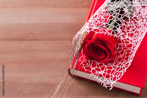  Red rose and red book on pink background, Sant Jordi holiday card photo