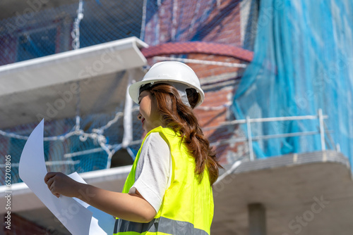 female architect checking construction plans