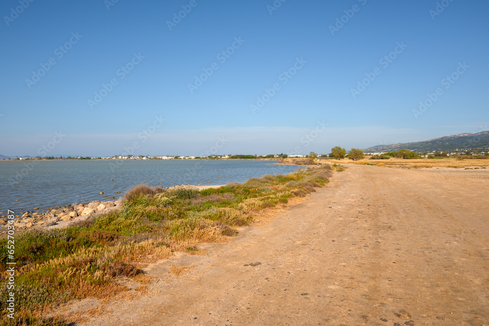 Gravel road along Tigaki salt lake (Alykes) on the island of Kos. Greece