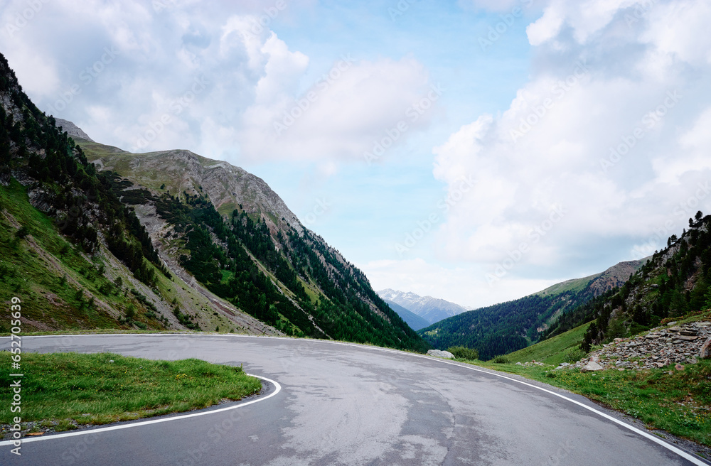 Fototapeta premium Asphalt road in Alps mountains. Road trip concept. Beautiful landscape.