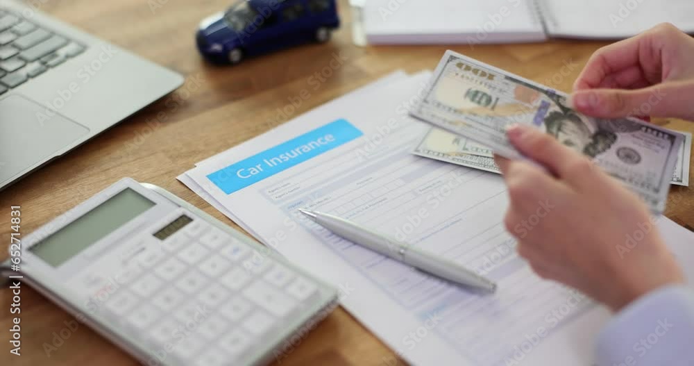 Auto insurance contract and agent counting dollar. Insurance payments Auto insurance contract and agent counting dollar. Insurance payments