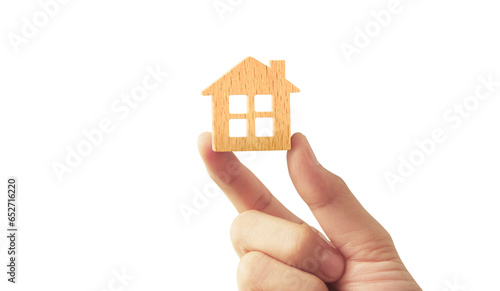 holding house representing home ownership and the Real Estate business