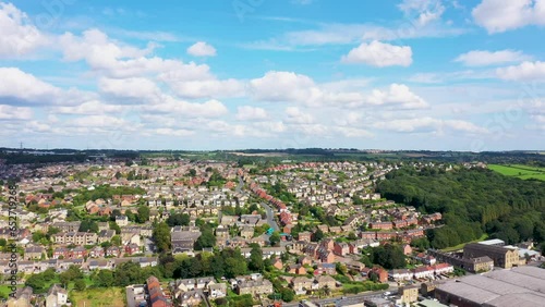 Aerial footage of the town of Batley in the UK, showing the housing estates on a sunny day in the summer with white clouds in the sky photo