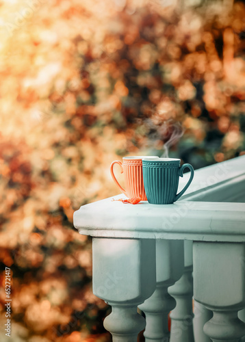 Wallpaper Mural Two cups of hot tea or coffee stand on the balcony parapet against the backdrop of autumn trees. Torontodigital.ca