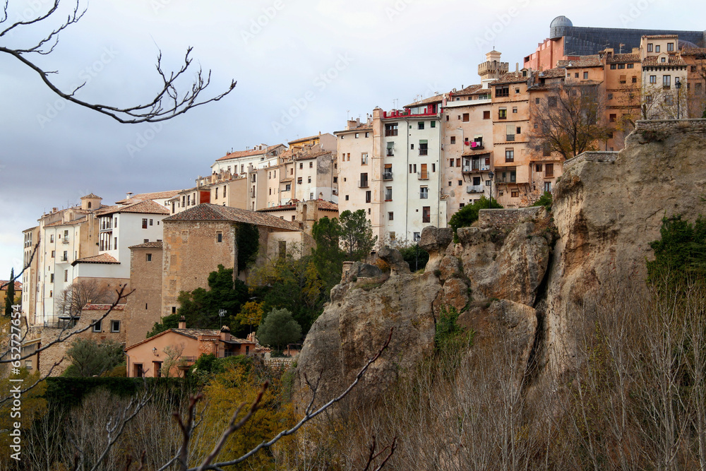 Cliffs and a row of colored houses against a stormy sky in the historic part of Cuenca, near Madrid, Spain