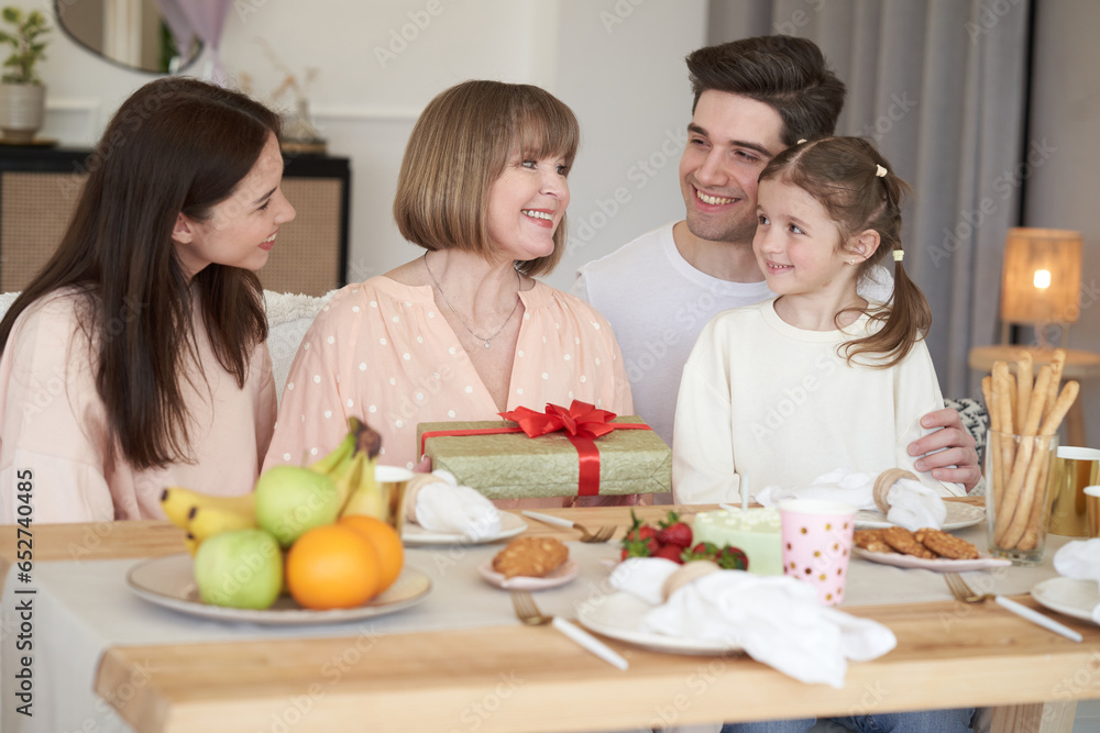 Family son his wife and granddaughter celebrate grandma birthday