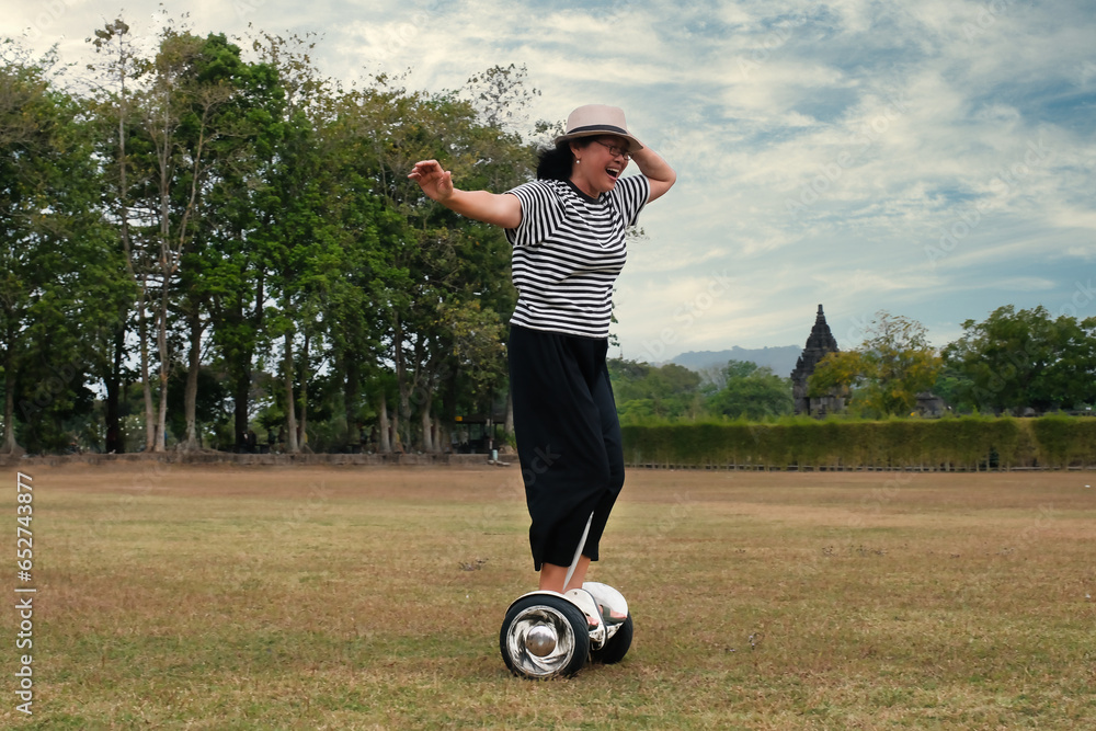 Fototapeta premium Woman riding a self balancing electric hover board