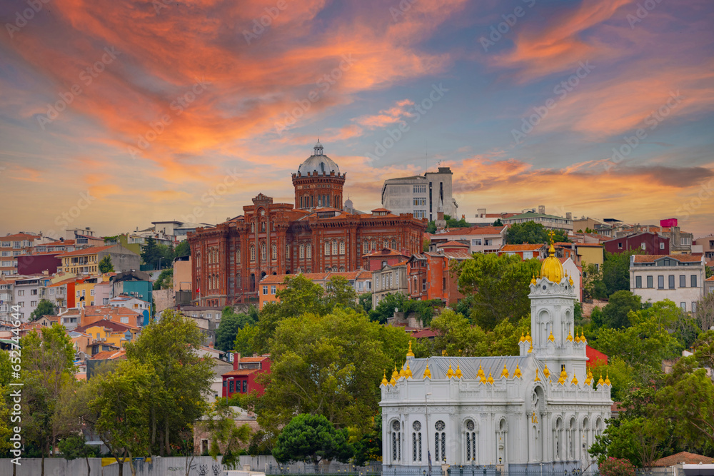 Fototapeta premium View from Golden Horn of Neo Byzantine architecture style Bulgarian St. Stephen Church, a Bulgarian Orthodox church, with Phanar Greek Orthodox College in the far end, Balat district, Istanbul, Turkey