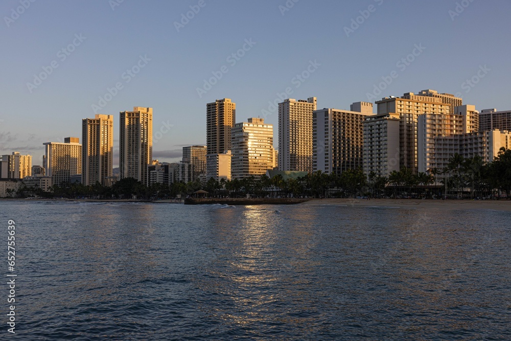City with tall buildings in the distance near the water