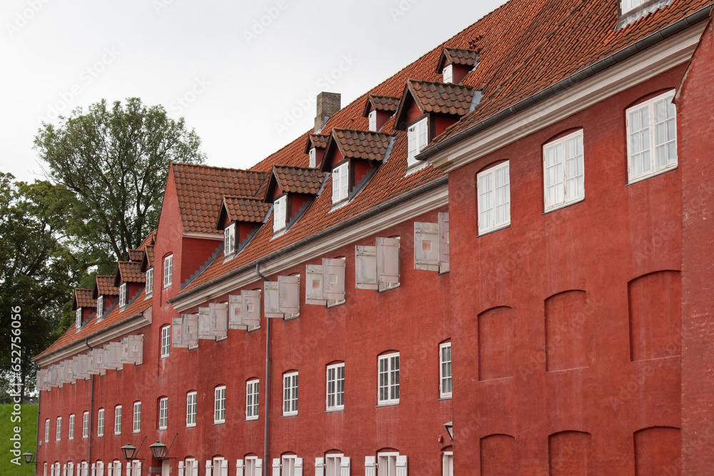 View of red traditional building in the Kastellet (The Citadel) of Copenhagen, Denmark, a well preserved fortress built in the form of a pentagon.