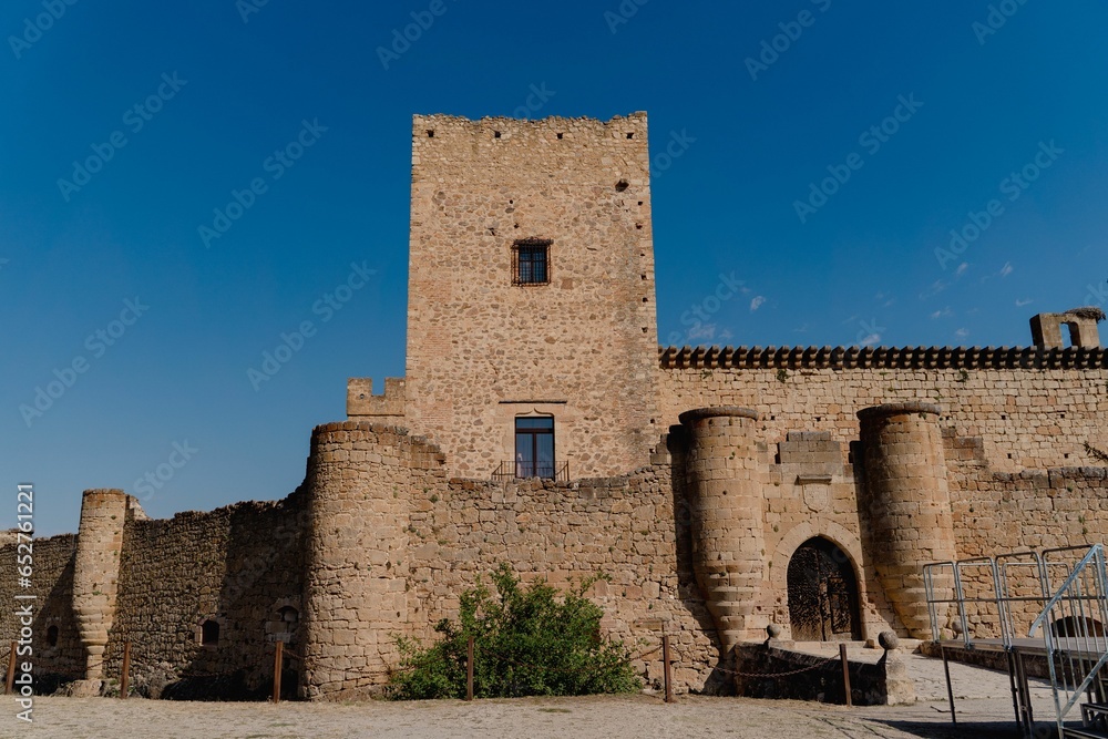 Front facade of the Pedraza castle against a clear blue sky