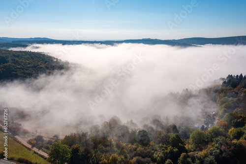 Bird's-eye view of the forests near Presberg/Germany in autumn and morning fog over the Wisper Valley in the background