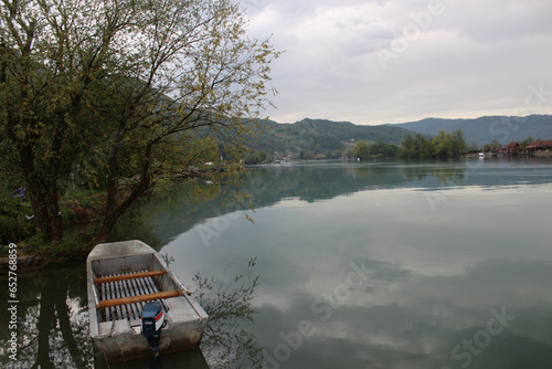 Wallpaper Mural Beautiful natural scenery of mistic river Drina in west Serbia. Green forest in background and boat tied on banches near the river. Spring morning shot. Torontodigital.ca