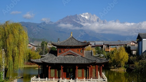 a building and some buildings with snow capped mountains in the background