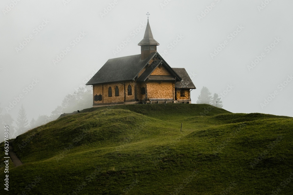 Exterior view of an old church on top of a hill in the Alpine region of Switzerland