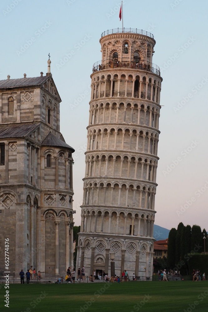 the people are standing in front of the leaning tower of pisa