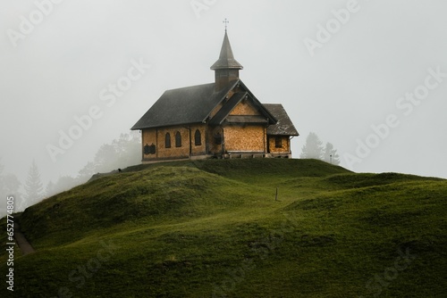 Exterior view of an old church on top of a hill in the Alpine region of Switzerland